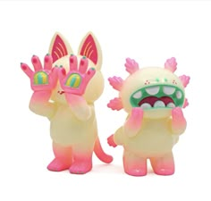 two plastic toys that look like they have teeth and hands in the shape of animals