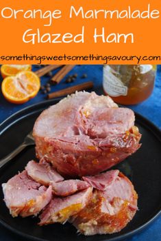 orange marmalade glazed ham on a black plate