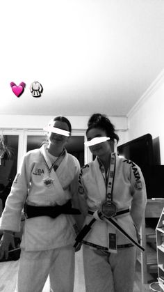 black and white photograph of two people in karate gear with their hands on each other's hips