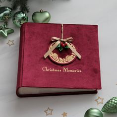 a christmas ornament on top of a red book