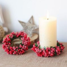 a white candle sitting on top of a wooden table next to other items and decorations