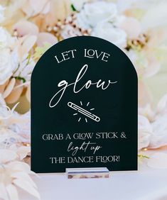 a sign that says let love glow grab a glow stick and light up the dance floor