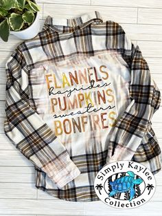 a plaid shirt with the words flannes pumpkins and bonfires on it