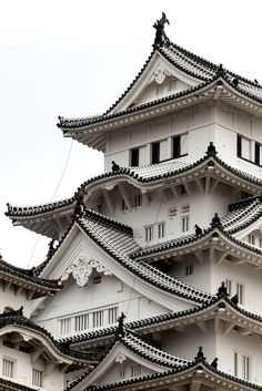 a tall white building with black roof tops