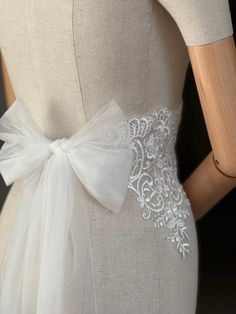 A stunning, elegant statement wedding sash is exquisitely  in beautiful vintage pattern. Your choice tulle  sash ties at the back into a bow. An ultimate luxurious accent piece for your wedding dress or for any special occasion dresses. Color ivory. Cream Wedding Dress With Satin Bow, Elegant White Bride Sashes, Elegant Bridal Sashes, Elegant Bridal Sashes For Bride, White Wedding Dress With Sashes, Elegant Ribbon Bridal Belt For Wedding, Elegant Bridal Belt With Satin Bow For Wedding, Fitted Lace Bridal Belt For Bride, White Fitted Bridal Belt For Ceremony