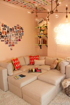 a living room filled with furniture and lots of pictures hanging on the wall above it