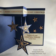 a christmas card with stars hanging from it