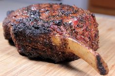 a piece of meat that has been cooked on a cutting board with some black stuff all over it