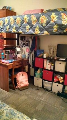 a bedroom with a bunk bed, desk and storage bins on the bottom floor