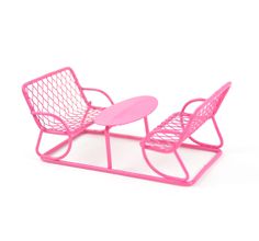 a pink plastic chair and ottoman on a white surface with a table in the middle