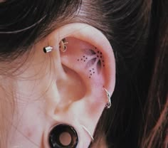 a woman's ear has a black and white design on it