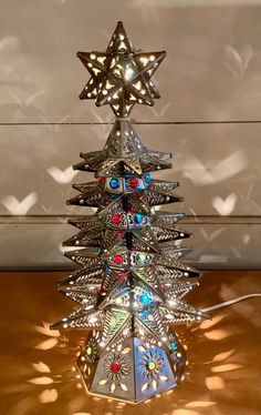 a metal christmas tree with lights on it