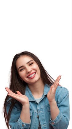 a young woman making the vulcan sign with her hands while standing against a white background