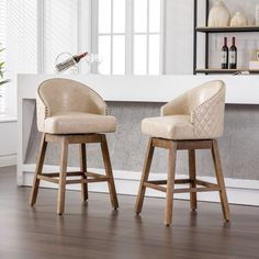 two beige bar stools in front of a fireplace