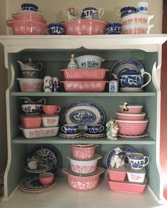 a china cabinet filled with lots of dishes and cups on top of it's shelves