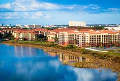 an aerial view of the resort buildings and lake in front of it, surrounded by tall buildings