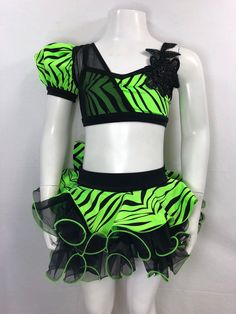 a female mannequin wearing a neon green and black outfit with zebra print on it