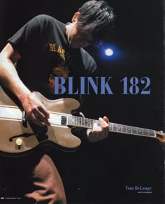 a man playing an electric guitar in front of a dark background with the words blink 822 on it