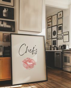 there is a sign that says chef's next to a kitchen with pictures on the wall