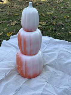 three white pumpkins stacked on top of each other