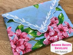 a blue envelope with pink flowers on it and the words hankie recipe envelope diy tutor