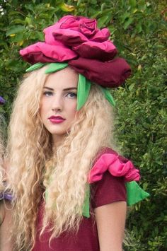 two women with long blonde hair wearing flower hats