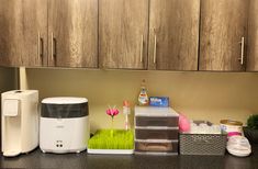 the kitchen counter is cluttered with cleaning products and other items, including an air purifier