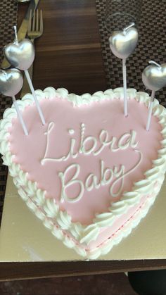 a heart shaped cake sitting on top of a table