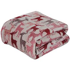 the red and white blanket is folded up on top of each other, with an elephant pattern