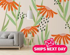 a couch sitting in front of a wall with flowers on it and the words ships next day