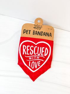 a red and white dog bandana that says rescue with love