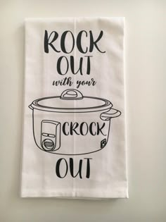 a kitchen towel with the words rock out with your crock pot on it