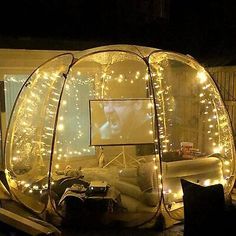 an inflatable tent is set up outside at night with lights on the inside