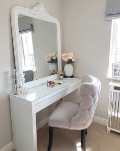 a white desk with a chair and mirror