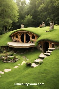 a green house with steps leading up to it's entrance in the middle of a forest