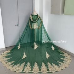 a green and gold wedding dress on display