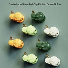 small round clip kitchen holder in assorted colors on grey background with text that reads snap - shaped mop clip kitchen holder