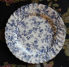 a blue and white plate sitting on top of a rug