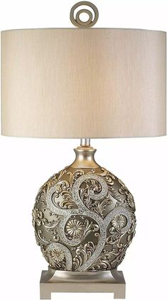 a table lamp with a beige shade on it and a light fixture in the middle