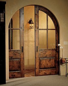 an open cell phone shows the front door to a home with glass and wood doors