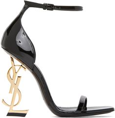 Patent calfskin heels in black. Open square toe. Strap at vamp. Adjustable pin-buckle ankle strap. Stiletto heel featuring logo hardware. Tonal leather sole. Gold-tone hardware. Approx. 4 heel. Supplier color: Black Ysl High Heels, Black Heels Prom, Black And Gold Shoes, Cute Black Heels, Gold Stilettos, Black Open Toe Heels, High Heels Black, Black Stiletto Heels, Ysl Heels