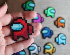 a hand holding a small piece of pixel art