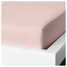 a close up view of a pink sheet on a bed with white frame and drawers