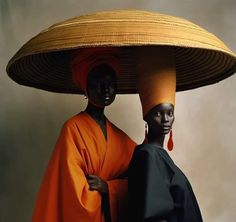 two african women wearing large hats and scarves