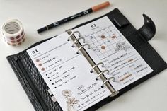 an open planner book sitting on top of a table