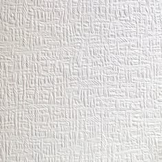 a white textured wallpaper with small squares and lines on the bottom right corner