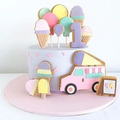 a cake with ice cream and popsicles on top is decorated in pastel colors