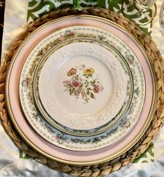 a table with plates and napkins on top of it, next to other place settings