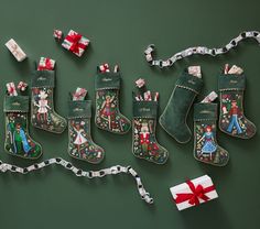 christmas stockings and presents laid out on a green surface