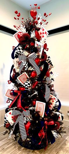 a decorated christmas tree with red, white and black decorations